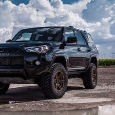 the front end of a black toyota 4runner