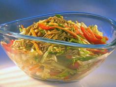 a glass bowl filled with lettuce and carrots