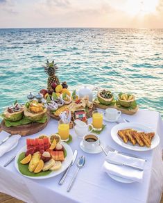 the table is set up for breakfast on the water