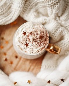 a cappuccino with cinnamon sprinkles and stars on the table