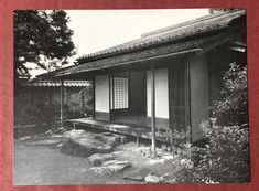 an old black and white photo of a japanese house