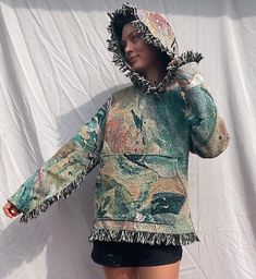 This is a one of a kind blanket / tapestry hoodie with my art. The fabric is woven 95% cotton and 5% poly blend to give the fabric a little more flexibility. Fabric is printed in America and the hoodies are stitched by me.  They are very high quality, unique, wearable art. This light green one measures 21 1/2 inches across and 25 1/2 inches from highest point of the shoulder to bottom (before fringe). Model is 5'9 and size 4/6 for reference. This one is a medium. Mediums are the smallest size I make. For longevity of the garment, it is best to spot clean/hand wash, but you can machine wash them in cold water. Hang to dry. Message me for customs. Artistic Long Sleeve Hoodie For Fall, Bohemian Cotton Hoodie For Festival, Artistic Hooded Hoodie For Fall, Bohemian Hoodie For Festivals, Bohemian Hooded Hoodie For Festivals, Tapestry Blanket Sweater, Tapestry Blanket Pants, Bohemian Winter Festival Hoodie, Tapestry Jacket