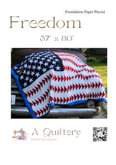 an american flag quilt sitting on top of a car with the words freedom written in it