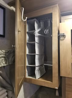 the inside of a travel trailer closet with towels and other items hanging on it's doors