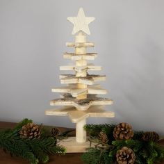 a christmas tree made out of wooden planks and pine cones