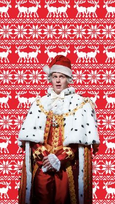 a man dressed in costume standing next to a red and white wall