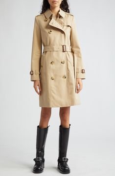 The iconic Burberry Heritage trench coat is expertly cut from water-resistant cotton gabardine with all the classic details, including the check lining. 38" length (size 8) Double-breasted button closure Point collar with throat latch Belted cuffs Front button-welt pockets Epaulets Button gun flap; storm flap Removable belt Back vent Lined 100% cotton with leather buckles Dry clean Made in the UK Designer Clothing Classic Gabardine Outerwear With Double-breasted Fastening, Classic Double-breasted Gabardine Outerwear, Designer Gabardine Outerwear, Leather Buckle, Elegant Fashion, Welt Pockets, Clothing Items, Double Breasted, Trench Coat