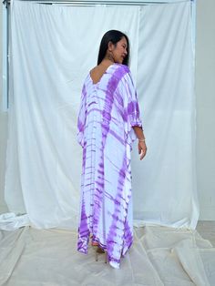 Dive into a world of vibrant color and unique patterns with our tie dye kaftan. Each piece is a masterpiece of individual hand tie-dyeing, ensuring that no two are alike. Crafted with meticulous care and attention, these kaftans offer a burst of style and creativity. Whether you're lounging at home, heading to the beach, or stepping out for an evening on the town, our tie dye kaftan is the perfect choice to make a bold and unforgettable fashion statement. Embrace the artistry and individuality o Tie Dye Flowy Tunic Kaftan, Flowy Tie Dye Kaftan Tunic, Tie Dye Flowy Maxi Kaftan, Flowy Tie-dye Tunic Kaftan, Casual Purple Kaftan For Spring, Flowy Tie Dye Maxi Kaftan, Purple Casual Spring Kaftan, Casual Purple Spring Kaftan, Tie Dye Kaftan With Natural Dye