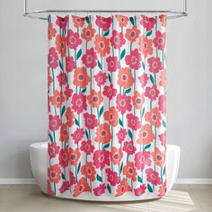 an orange and pink flower shower curtain hanging from a metal rod on a white wall