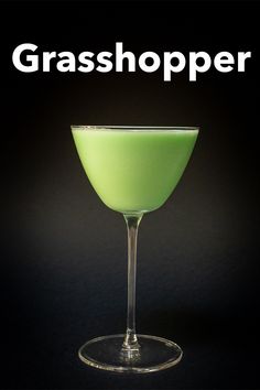 a green drink in a wine glass with the words grasshopper on it's side