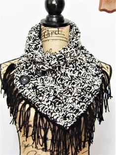 women's winter fringe crochet scarf/black white neck scarves/brown flecks Hand Crocheted Scarf with Buttons. Very pretty black and white medium weight yarn. The collar is adjustable.  See picture. It is 35 inches long x 9 inches wide minus the 5 inch black fringe. Slips over the head and is blanket stitched around the bottom edges. Three large plastic black buttons allow extra room to slip over your head. Should fit the average size woman, one size. Double crochet pattern. Worked with two strands of yarn black and white tweed. The acrylic white yarn is a tweed with brown flecks. Ideal for your winter outfits or as a gift that will be appreciated. Made with love in my shop...USA I recommend hand wash in wool lite because of the fringe. Dry on rack.    You receive the item pictured here as I Black Crochet Scarves For Winter, Bohemian Black Cotton Scarves, Scarf With Buttons, Black Cotton Winter Scarf, Average Size Women, Fringe Crochet, Gothic Crochet Scarves & Shawls, Button Scarf, Crocheted Scarf