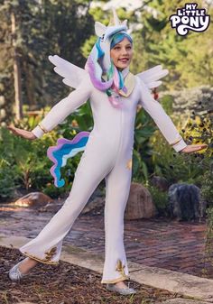 a woman in a white unicorn costume is posing for the camera with her arms outstretched