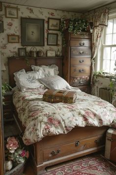 an old fashioned bedroom with floral wallpaper and bed linens on the floor, along with antique furniture