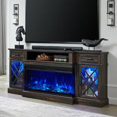 an entertainment center with a fireplace in the middle and blue flames on it's sides