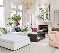 a living room filled with lots of furniture and flowers in vases on the wall