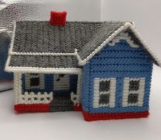 a small knitted house sitting on top of a table