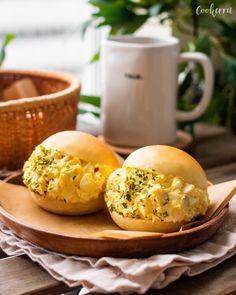 two eggs are sitting on a plate next to a cup