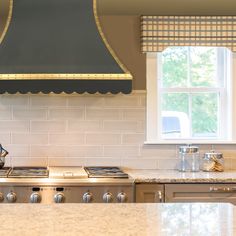 a stove top oven sitting inside of a kitchen