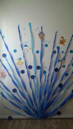 there are blue toothbrushes arranged in the shape of a peacock on this wall