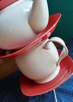 two red and white dishes stacked on top of each other