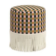 a small stool with fringes on the bottom and an orange, green, black and white checkerboard pattern