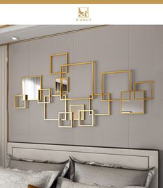 a modern bedroom with gold frames on the wall