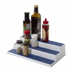 spices and condiments are arranged on a blue striped serving tray with white stripes