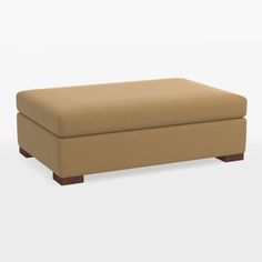 a tan footstool sitting on top of a white floor