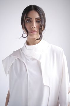 All around layered in mixed material with front functional pocket Fits true to size, loose fit Model wears size S Model is X and Y, she is wearing size Z 65% cotton, 35% polysterDry Clean OnlyMade in Armenia Luxury Asymmetrical Hem Tops For Layering, Modern White Tops For Layering, White High Neck Blouse For Spring, White Turtleneck Top For Layering, White Stand Collar Top For Work, White Funnel Neck Top For Layering, White Asymmetrical Tops For Work, White Asymmetrical Tops For Workwear, White Turtleneck Tops For Work