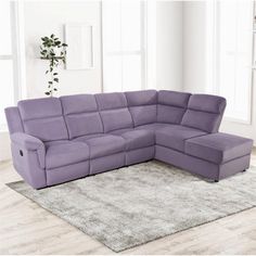 a purple sectional sofa sitting on top of a rug