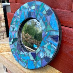 Mosaic Stained glass mirror 8" Beach house decor Mosaic MIRROR handmade of colorful art one of a kind.  *MIRROR MEASURES 8"inches round /slotted in back ready to hang once custom-made for you! *Crafted of wood and mosaic tumbled glass. This Beautiful one of kind Mosaic frame was Handmade designed by GardenGoddessMosaics. Especially made by me for your decor or gift giving!  Due to custom nature sorry no refunds or exchanges. Perfect for any Beach lover! Great House warming gift This art piece is much more beautiful in person! Handmade Vibrant turquoise and Glass tiled art through out. Custom made to use in your home decor  PLEASE REMEMBER: ALL ITEMS ARE HAND-MADE AND HAVE NATURAL VARIATIONS AND QUIRKS, AS WELL AS VARYING TILE THICKNESSES,  NO MATTER HOW MUCH I TRY TO MAKE EVERYTHING PERFEC Wall Ceramic Tiles, Tile Stained, Painted Trim, Stained Glass Mirror, Wall Ceramic, Mirror Handmade, Grey Grout, Art Pierre, Mosaic Frame