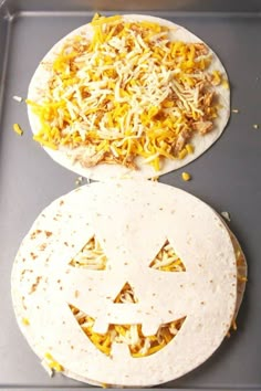 two tortillas with shredded cheese and jack - o'- lantern faces on them