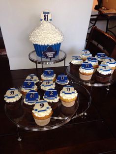 cupcakes with blue and white frosting are on a table