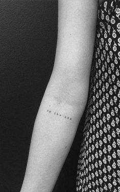 a woman's arm with the word love tattooed on her left arm, in black and white