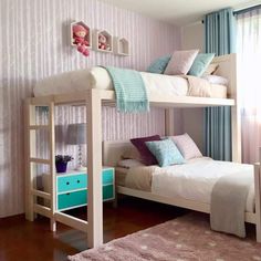 a bedroom with two bunk beds and a pink rug on the floor next to it