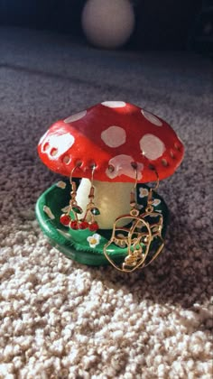 a red and white mushroom sitting on top of a green plate in the middle of carpet