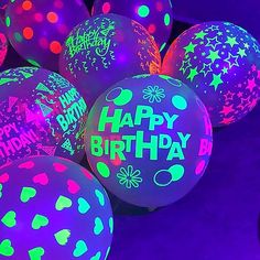 glow in the dark balloons with happy birthday written on them and stars all over them