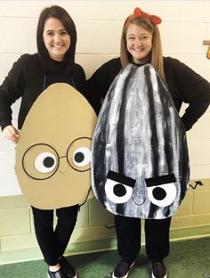 two girls in costumes standing next to each other