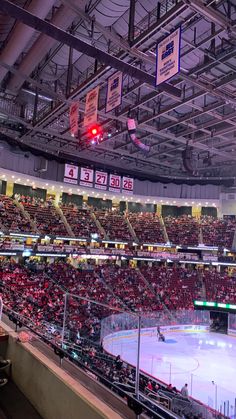 an indoor hockey stadium with fans and lights