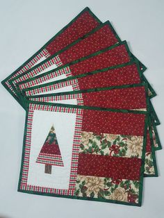 six christmas placemats are stacked on top of each other, one has a tree in the center