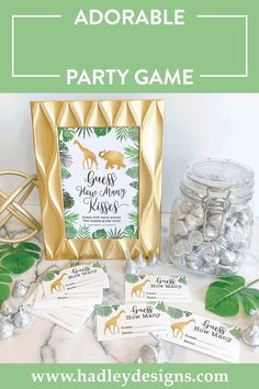 some baby shower games are on the table with gold frames and green leafy leaves