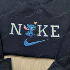 Introducing the Nike Stitch Love Embroidered Sweatshirt, a perfect blend of comfort and style. This hoodie features a stunning Lilo and Stitch embroidered design, adding a touch of fun and nostalgia to your wardrobe. Made with premium quality materials, it offers supreme warmth and durability. The custom Nike logo shirt is a must-have for any Nike enthusiast. With its personalized design, it allows you to showcase your unique style while staying true to the iconic Nike brand. Crafted with utmost Cute Hooded Tops With Embroidered Logo, Cute Hooded Top With Embroidered Logo, Cute Custom Embroidered Crew Neck Hoodie, Cute Hoodie With Custom Embroidery And Crew Neck, Cute Hooded Hoodie With Embroidered Logo, Cute Hooded Sweatshirt With Custom Embroidery, Cute Embroidered Crew Neck Hoodie, Cute Hooded Sweatshirt With Embroidered Graphics, Cute Embroidered Long Sleeve Hoodie