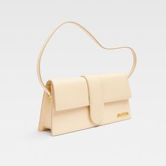 The long Bambino in ivory is the perfect accessory for anyone looking to make a statement. Crafted from luxurious calf leather with tonal stitching, this bag exudes sophistication and style. The detachable shoulder strap adds versatility, while the gold-tone logo lettering adds a touch of elegance. With a spacious main compartment and internal pockets, this bag is both practical and fashionable. Elevate any outfit with the Bambino in Orange! Luxury Beige Baguette Bag With Top Handle, Luxury Beige Top Handle Baguette Bag, Luxury Beige Baguette Bag With Detachable Strap, Luxury Beige Baguette Bag With Detachable Handle, Luxury Beige Baguette Bag With Double Handle, Luxury Beige Baguette Bag With Adjustable Strap, Luxury Beige Baguette Bag For Evening, Beige Leather Baguette Bag For Formal Occasions, Elegant Beige Leather Baguette Bag