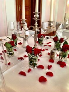 a table with roses and candles on it