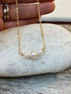 "7-7.5mm and 5-5.5mm White rose tone Akoya Culture Pearl (from Japan) in 14K Gold filled or Serling silver chain Beautiful Elegant and Classic look. Perfect gift for any occasion Holidays, Birthday or just something nice as a gift ◈ Handmade in the U.S.A. ◈ Akoya Culture Pearl: 1 / 7-7.5mm and 2 / 5-5.5mm white rose tone pearls ◈ Metal: 14K gold filled or sterling silver ◈ Chain Length:15\" 16\" 17\" 18\" 19\" 20\" free shipping and a gift 🎁 My jewelry will be wrapped in a beautiful gift box re Rose Gold Akoya Pearl Necklace Gift, Rose Gold Pearl Necklace With Round Beads For Gift, Pearl Bar Necklace, Necklace Friendship, Bar Necklaces, Akoya Pearl Necklace, Rose Tone, Cultured Pearl Necklace, Black Bead Necklace