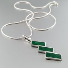 Mens silver chain pendant necklace Malachite gemstone, Sterling silver handmade jewelry for men, Unique gifts for men Gnatus geometrically designed Sterling silver pendant with natural lapis lazuli gemstone inlay. This beautiful pendant is worked with the technique of inlay, which means the stone is worked seamlessly into the Sterling silver. The inlay is made from natural Malachite gemstone, which has a rich deep green color. The Pendant features: ▪️ Genuine Malachite [12x5x1mm] ▪️ 925 Sterling Modern Green Necklace With Polished Finish, Modern Green Rectangular Pendant Jewelry, Silver Chain For Men, Unique Gifts For Men, Sterling Silver Jewelry Handmade, Men's Necklace, Gemstone Necklace Pendant, Pendant Design, Sterling Silver Hoops