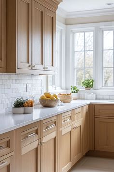 a kitchen with wooden cabinets and white counter tops next to a bowl full of fruit