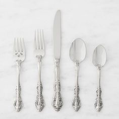 five silverware pieces with ornate designs on them