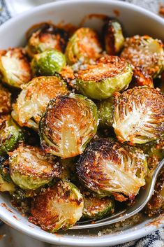 a white bowl filled with brussel sprouts on top of a table