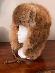 Experience ultimate luxury with our handmade Baby Alpaca Fur Trapper Hat. Crafted in the Andes region of Peru, this hat feels like a cozy cloud hugging your head. Perfect for outdoor activities like hiking, hunting, or living off-grid, it’s loved by hunters for its exceptional warmth—warmer than polar bear fur—while also regulating heat. Stay comfortable without overheating, as it adjusts to keep you warm when needed and cool when it’s not. The hypoallergenic baby alpaca fur on this Alpaca Fur T Adjustable Alpaca Hat For Outdoor, Alpaca Hat For Outdoor Winter Use, Winter Outdoor Alpaca Hat, Brown Hats With Ear Flaps For Outdoors, Brown Hats With Ear Flaps For Outdoor Activities, Warm Brown Hats For Outdoor Activities, Warm Brown Hat For Outdoor Activities, Sheepskin Hats With Ear Flaps For Outdoor, Sheepskin Outdoor Hat With Ear Flaps